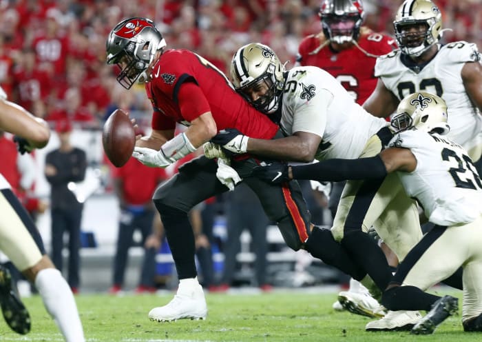Dec 19, 2021; New Orleans Saints defensive end Cameron Jordan (94) tackles Tampa Bay Buccaneers quarterback Tom Brady (12) and forces a fumble the ball during the second half. Mandatory Credit: Kim Klement-USA TODAY Sports